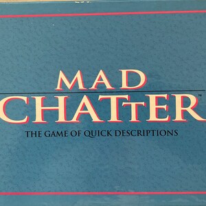 May include: A blue box with a red border and the text "MAD CHATTER" in white with a red outline. The text "THE GAME OF QUICK DESCRIPTIONS" is in white below the title.