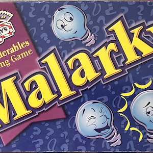 May include: The board game "Malarky" features a purple and blue design with the game's title in large yellow letters. The box includes lightbulb characters with expressive faces and the text "As Played at T.G.I. Friday's". The game is described as "An Imponderables Bluffing Game".