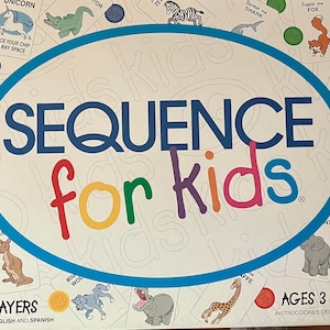 May include: A Sequence for Kids board game box featuring a white background with a large blue oval containing the title text. The box displays various animal playing cards, colorful circular game chips, and text indicating 2 to 4 players and ages 3 through 6.