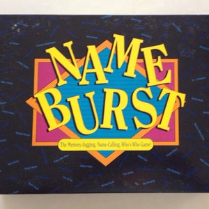 May include: A black box game called "Name Burst" with a yellow, blue, and pink design. The text "The Memory-Jogging, Name-Calling, Who's Who Game?" is printed on the box.
