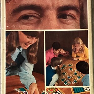 May include: Vintage Parker Brothers "SCAN" split-second matching game box. The box features a collage of images, including a close-up of eyes and people playing the game. The game's title is in large teal letters.