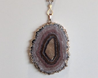 Left and right balance - amethyst/quartz pendant necklace with amethyst, kunzite, rhodochrosite, pink sapphire and gold-filled spirals