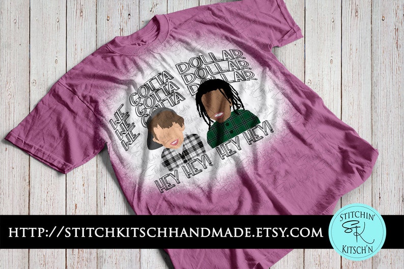 May include: A pink t-shirt with a graphic design featuring two cartoon figures and the words "GOTTA DOLLAR" and "HEY HEY!" in black. The Etsy shop URL is at the bottom.