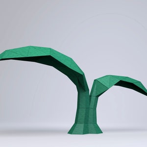 May include: A green origami palm tree with two leaves, made of paper. The tree is standing on a white surface.