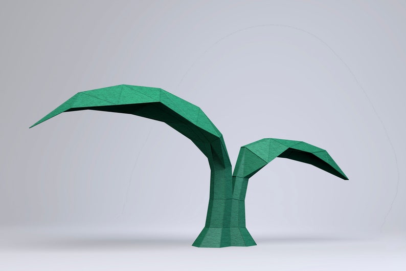 May include: A green origami palm tree with two leaves, made of paper. The tree is standing on a white surface.
