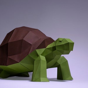 May include: An origami tortoise sculpture made from green and brown paper. The tortoise has a detailed, geometric design.