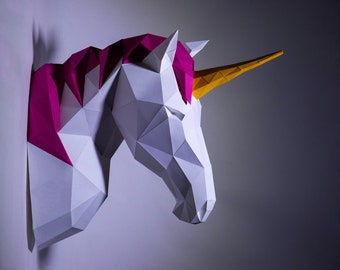 May include: A white paper unicorn head sculpture with a pink mane and a yellow horn. The sculpture is made of folded paper and has a geometric design.