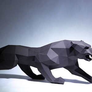 May include: A black papercraft sculpture of a panther in a crouching pose. The sculpture is made of folded paper and has a realistic appearance.