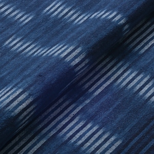May include: Blue fabric with a white stripe pattern. The fabric has a textured, woven look.
