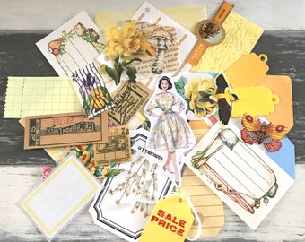 May include: A collection of yellow and white paper ephemera with floral and botanical designs. The ephemera includes tags, tickets, and other paper crafts. The text "SALE PRICE" is printed on a yellow tag.
