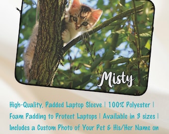 May include: A personalized laptop sleeve featuring a photo of a tabby kitten perched on a tree branch. The sleeve is made of 100% polyester and has foam padding to protect laptops. The text "Misty" is printed on the sleeve.