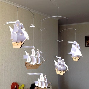 Five beautiful wooden sailboats with snow-white sails. Beautiful decor for any room in the house. Children&#39;s mobile.