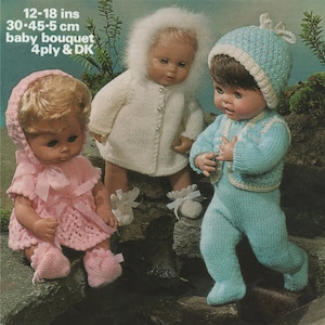 May include: Three knitted doll outfits for 12-18 inch baby dolls. The outfits are in pink, white, and blue. The outfits include a dress, a coat, and a jumpsuit. The outfits are made with 4 ply and DK yarn.