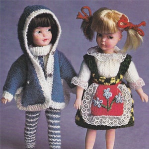 May include: Two knitted doll outfits. One is a blue and white striped jacket and trousers with a white hooded scarf. The other is a white sweater with a green and yellow waistcoat and a red and white embroidered apron.