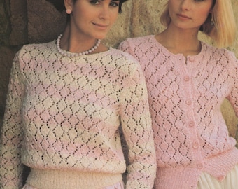 May include: Two women wearing pink and white knitted sweaters with a diamond pattern. The woman on the left is wearing a pink skirt and a pearl necklace. The woman on the right is wearing a white skirt and a cardigan.