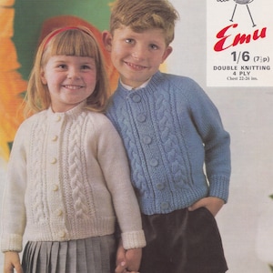 May include: Two children wearing knitted cardigans. The girl is wearing a white cardigan with a cable knit pattern and a black and white plaid skirt. The boy is wearing a light blue cardigan with a cable knit pattern and black shorts. The image includes the text "Emu 1/6 (7p) Double Knitting 4 Ply Chest 22-26 ins."