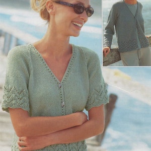 May include: A light green knitted cardigan with a v-neck and short sleeves. The cardigan has a button closure and a delicate lace pattern around the neckline and sleeves.