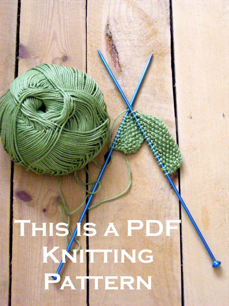 May include: A green ball of yarn with two blue knitting needles and a small green knitted piece. The text "THIS IS A PDF KNITTING PATTERN" is written below the yarn and needles.