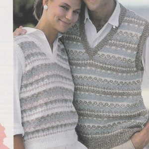 May include: A couple wearing matching striped knit vests. The woman is wearing a white shirt and white pants. The man is wearing a white shirt and beige pants.