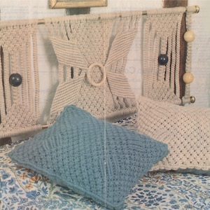 May include: A macrame headboard with a woven design and wooden beads. Two pillows are on the bed, one is blue and the other is beige.