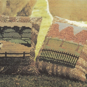 May include: Two knitted pillow covers with nature scenes. One features a green field with a white sheep and a brown fence. The other has a brown fence and three pink trees in a field.