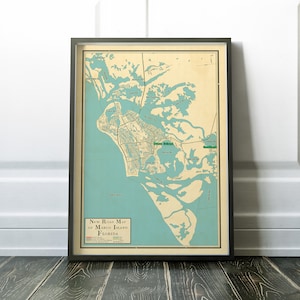 May include: Vintage map of Marco Island, Florida, in a black frame. The map shows the island's roads, waterways, and landmarks. The title "New Road Map of Marco Island, Florida" is printed at the bottom of the map.
