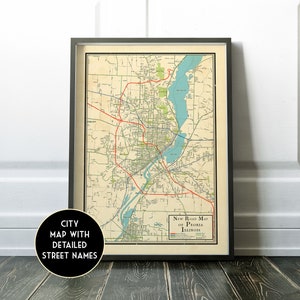 May include: Vintage style road map of Peoria, Illinois with detailed street names. The map is printed on cream colored paper and framed in a black frame.