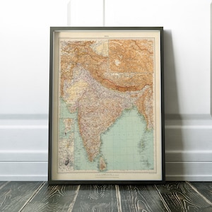 May include: A framed vintage map of India, printed in brown, green, and blue tones. The map shows the borders of the country and includes the text "INDIA" at the top.