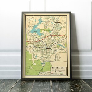 May include: A vintage style road map of Tallahassee, Florida. The map is printed on cream colored paper and features a green and brown color scheme. The map shows roads, streets, and landmarks. The title "New Road Map of Tallahassee, Florida" is printed at the bottom of the map.