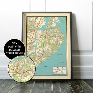 May include: Vintage map of Staten Island, New York City, with detailed street names. The map is printed in black, red, green, and blue on a cream-colored background. The map is framed in a black frame.