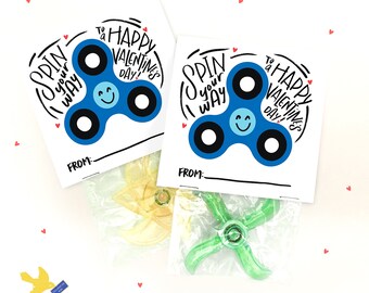 May include: Two Valentine's Day gift tags with a blue fidget spinner design. The tags say "Spin your way to a Happy Valentine's Day!" and have a space to write "From:".