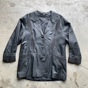 May include: A black leather jacket with a button fastening and decorative stitching. The jacket has a collar and long sleeves.