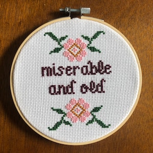 miserable and old cross stitch
