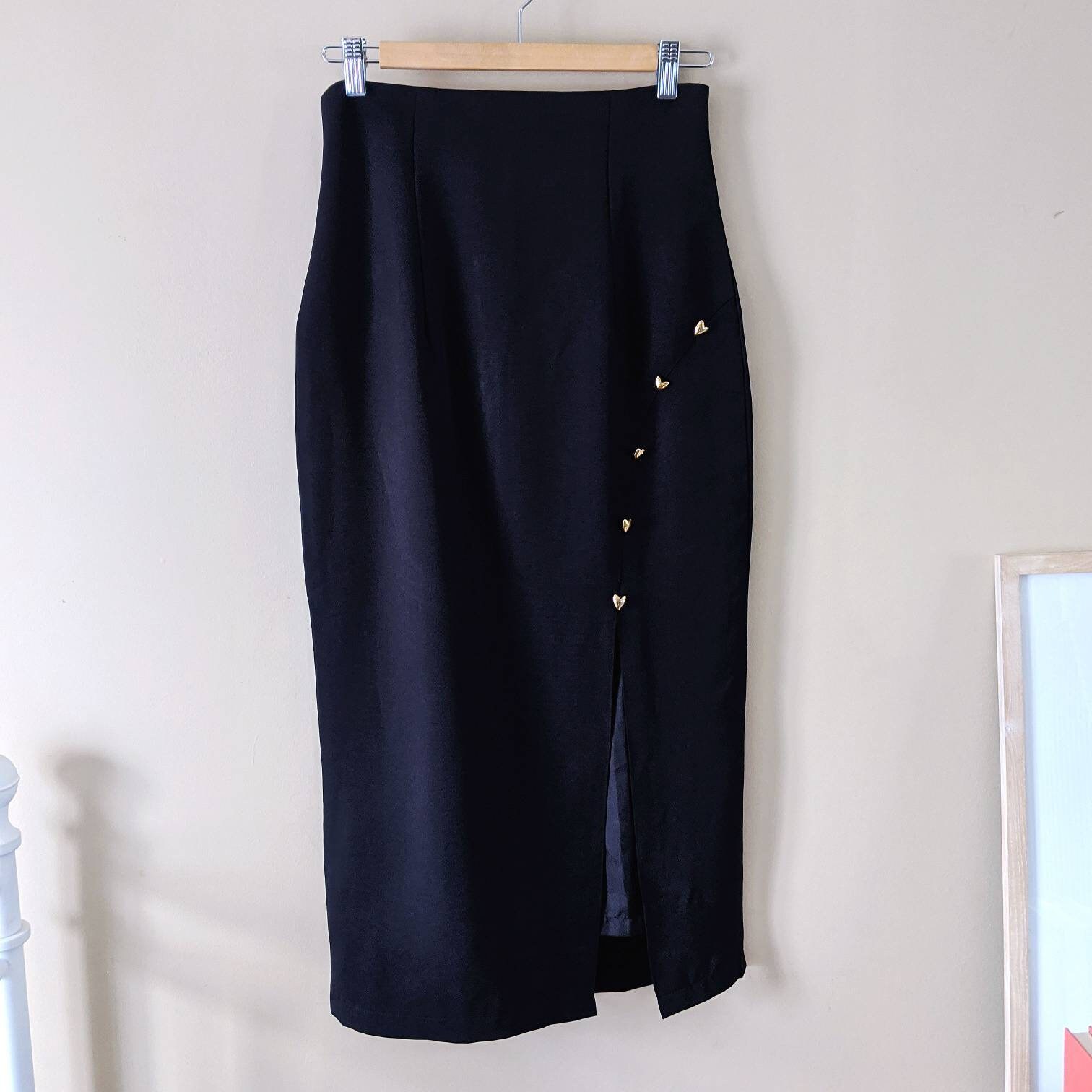 A Black Pencil Skirt With Gold Button Details