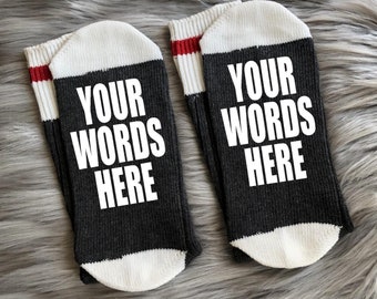 May include: A pair of black and white socks with red stripes. The socks have the text "YOUR WORDS HERE" printed on them.
