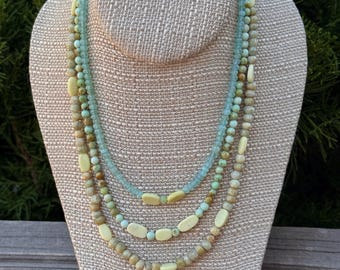 Autumn Eve. 3 strand Beryl and Blue Chalcedony facets, Maya Jade rounds and New Jade flat ovals. Silver filled brass slide and lock clasp.