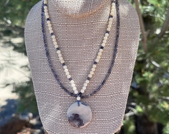 Blue Swirl. 2 strand Iolite & White Coral with a banded Agate round drop. Delica glass spacer beads. Sterling Silver toggle clasp. 18 inches