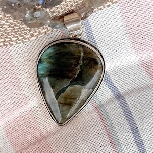Let It Rain! 3 strand Labradorite necklace with a beautiful teardrop pendant. Slide and lock silver filled brass clasp. 20 inches long
