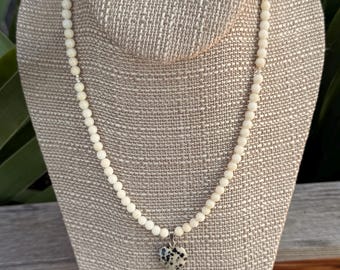 Dog on the Beach. Dalmatian Jasper heart pendant on White Coral round beads. Silver filled toggle clasp. 17 inches long. Creamy white color