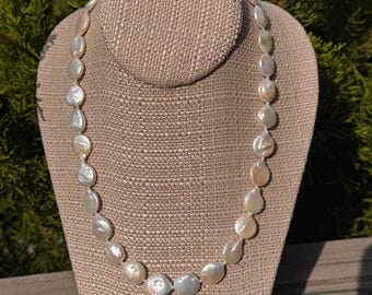 Coin Pearls. Adjustable length blistered coin pearls from 18 to 18 3/4 inches long. Sterling Silver toggle clasp. Classic June's birthstone.