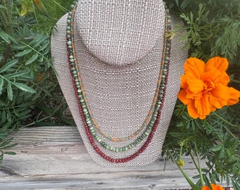 Marigolds in a Terracotta Pot. Green Quartz, Olive Chrysoprase, Red Jasper & Spessartite. Silver filled slide and lock flower clasp. 20 1/2"