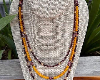 Viola Blooms, 3 strand necklace. Citrine, Delica Glass spacer beads, Garnet, Pearls, Yellow Calcite and a slide and lock flower clasp. 21.5"