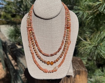 3 strand Autumn Jasper, Peach Moonstone facets, Red Agate rounds, Sunstone and a Sterling Silver toggle clasp. Sun and Moon necklace.