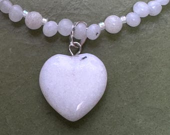 Snow White. Snow and Grey Quartz beads with a Snow Quartz heart pendant and a Silver filled round toggle clasp.  18 3/4 inches long.