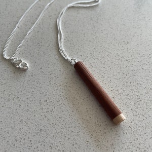 Dark wood pendant on recycled sterling silver chain, cylindrical with contrasting pale ash wood tip