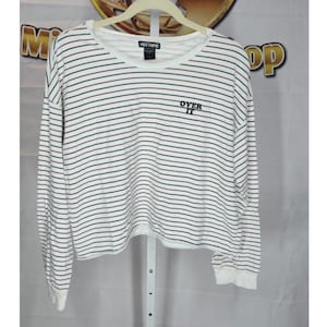 May include: White long-sleeve shirt with horizontal black and burgundy stripes. The shirt has a crew neck and the words "OVER IT" embroidered in black on the front. The shirt is from the brand Hot Topic.