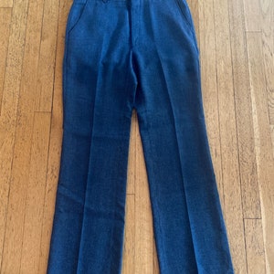 May include: A pair of dark blue, straight-leg pants with a white waistband.