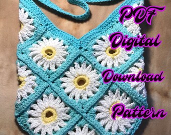 May include: A crochet bag with a daisy pattern in white and yellow, with a turquoise blue background. The bag has a long strap and the text "PDF Digital Download Pattern" is written in pink on the image.