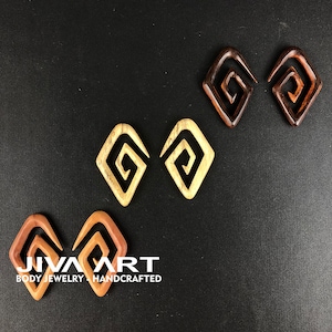 May include: Three pairs of wooden ear gauges with a spiral design. The gauges are in different shades of brown and beige.