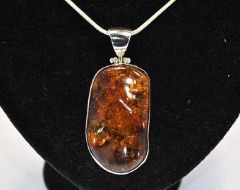 Big pendant with amber setting